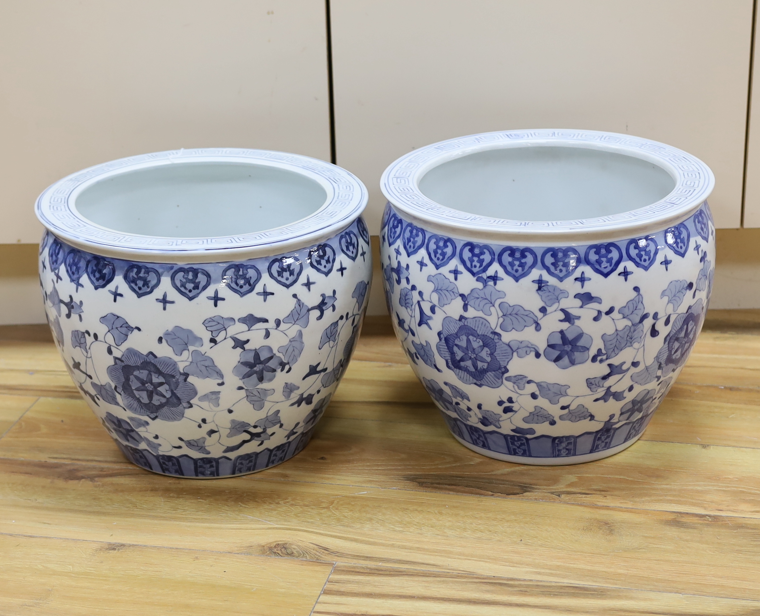 A pair of 20th century Chinese blue and white fish bowls, 29cm high